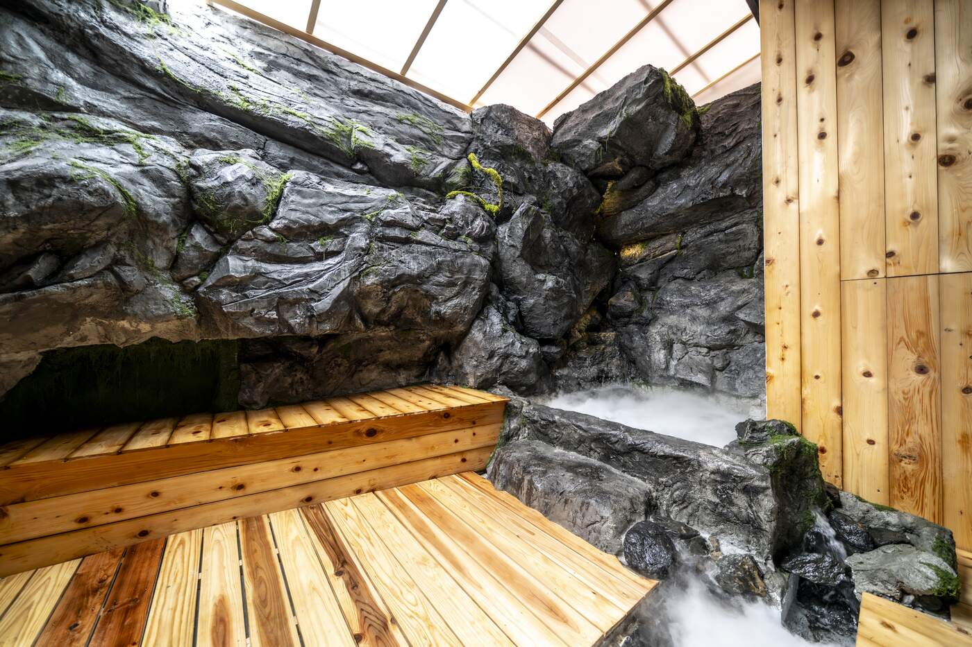 Open-air stone bath with steam rising